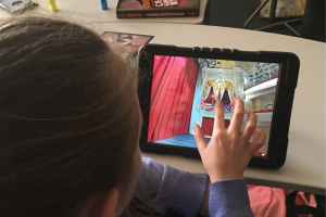 A girl uses a tablet computer to access a virtual tour of Ford's Theatre stage. 