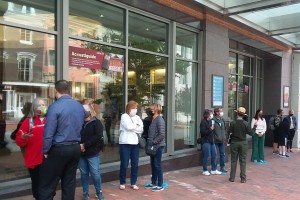 Patrons stand outside of Ford's Theatre wearing face masks and awaiting their timed entry to the lobby.