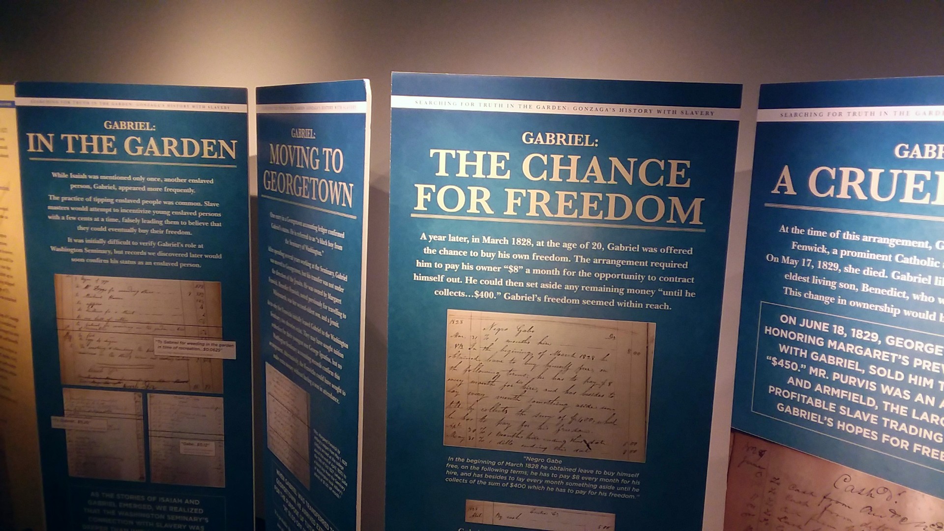 Several blue museum display panels line the walls of the Center for Education and Leadership.