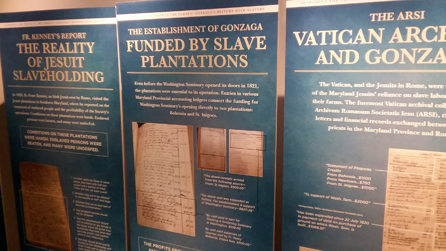 Blue presentation panels line the walls of the Center for Education and Leadership. On the panels is information researched by Gonzaga College High School about their institution's connections to slavery.