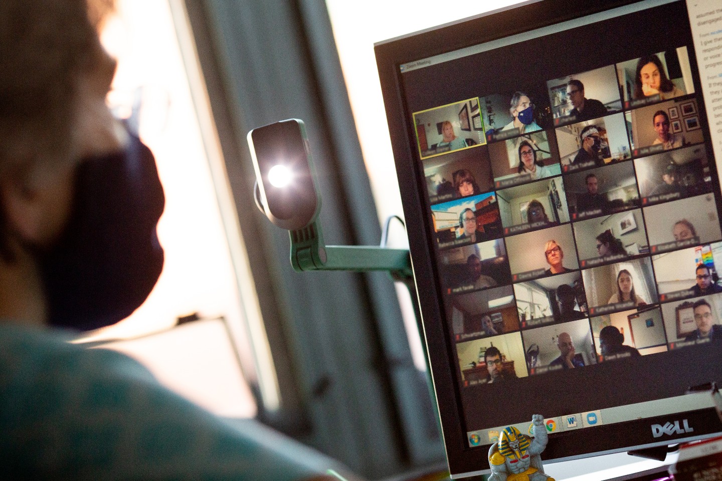 A teacher participates in an online staff meeting alone in her classroom at Middletown High School.