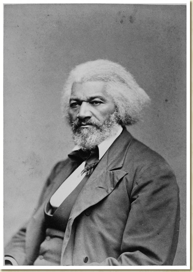Black-and-white photograph of Frederick Douglass in a three piece suit, and tie. Photographed from the waist up.